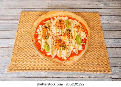 Tex Mex Pizza Recipe With Guacamole, Tinga Chicken Meat And Jalapeños With Mozzarella Cheese With Tomato And With Chickpea Flour Dough