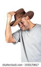 Texan Working Cowboy Of Mixed Race Isolated On White Background, Saluting Somebody With The Hat