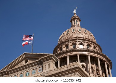 Texas capitol with the dome and use and texas flag blowing in breeze