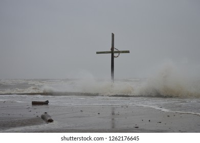 The Texas Coast Erupts Into A Sudden Storm With Angry Waves Whipping A Landmark Cross.