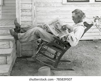 Texas farmer reading 'Progressive Farmer-Southern Ruralist' magazine in Sept. 1931. Founded in 1886, in the 1930s it advocated as rural electrification, soil conservation, rural education, and modern