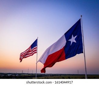 Texas Flag And American Flag At Sunset Over Country Side