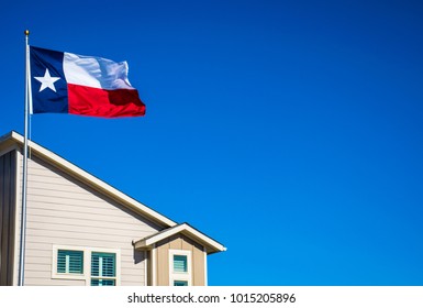 Texas Flag On Perfect Flagpole Flying In Front Of Brand New Modern Home In New Suburb In Austin , Texas The Capital City Of Texas In The Lone Star State