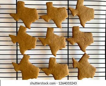 Texas shaped gingerbread cookies on a cooling rack