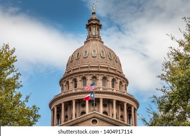 Texas State Capitol Building in Austin, with the flag of Texas and the USA