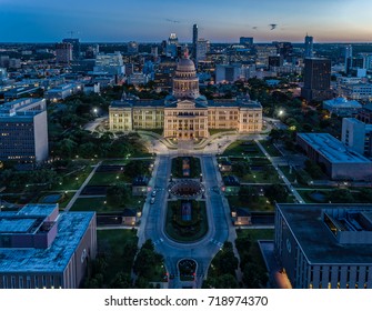 The Texas State Capitol Building in Austin, Texas featuring the Austin skyline during twilight