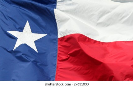 Texas state flag blowing in a strong wind.