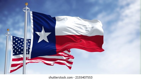 The Texas state flag waving along with the national flag of the United States of America. Texas s a state in the South Central region of the United States