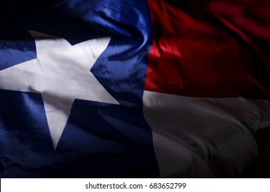 The Texas state flag waving in shadow