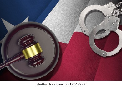 Texas US state flag with judge mallet and handcuffs in dark room. Concept of criminal and punishment, background for guilty topics