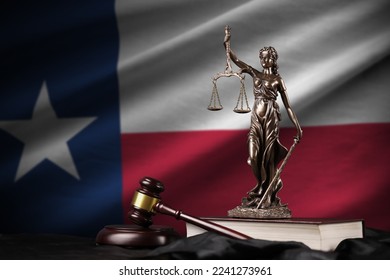 Texas US state flag with statue of lady justice, constitution and judge hammer on black drapery. Concept of judgement and punishment