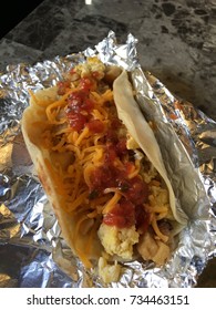 Tex-mex Flour Tortilla BreakFast Taco With Scrambled Eggs And Bacon And Potatoes  On Foil 