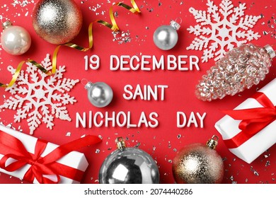 Text 19 December Saint Nicholas Day and festive decor on red background, flat lay - Powered by Shutterstock