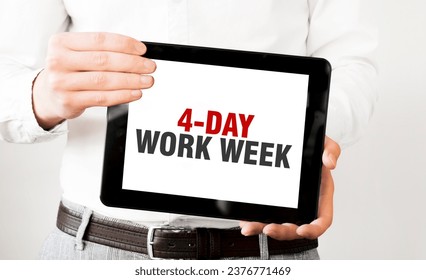 Text 4 day work week on tablet display in businessman hands on the white background. Business concept