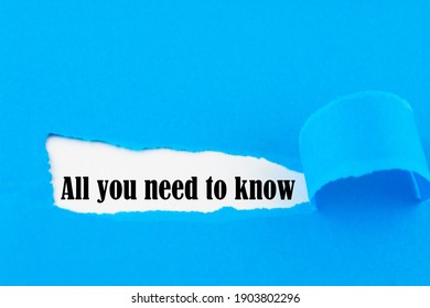 Text All You Need To Know Appearing Behind Ripped Blue Paper