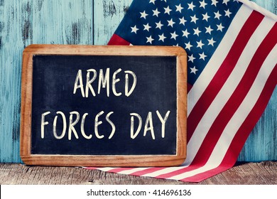 the text armed forces day written in a chalkboard and a flag of the United States, on a rustic wooden background