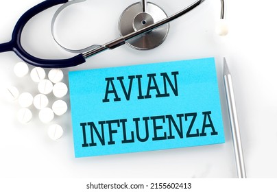 Text AVIAN INFLUENZA on a table with stethoscope,pills and pen, medical concept.