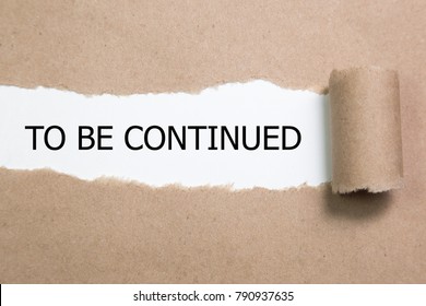 The Text To Be Continued Appearing Behind Torn Paper