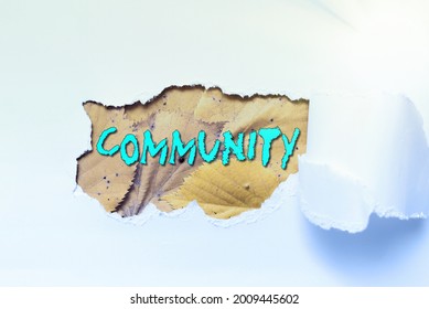 Text caption presenting Community. Conceptual photo group of showing with a common characteristics living together Tear on sheet reveals background behind the front side