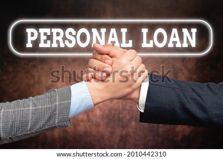 Text caption presenting Personal Loan. Business idea borrowing a fixed amount of money from a bank or credit union Two Professional Well-Dressed Corporate Businessmen Handshake Indoors