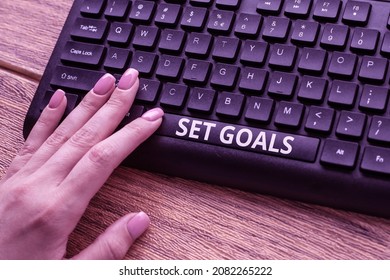 Text caption presenting Set Goals. Word Written on Defining or achieving something in the future based on plan Hands Pointing Pressing Computer Keyboard Keys Typewriting New Ideas.