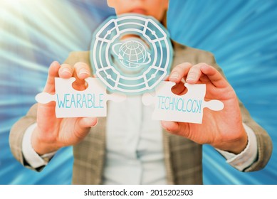 Text Caption Presenting Wearable Technology. Business Concept Electronic Devices That Can Be Worn As Accessories Business Woman Holding Jigsaw Puzzle Piece Unlocking New Futuristic Tech.