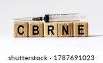 Text CBRNE made from wooden cubes. White background