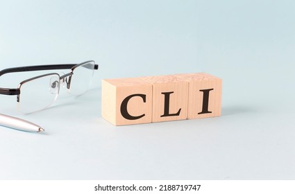 Text CLI - Command Line Interface - Written On Wooden Cubes On Blue Background