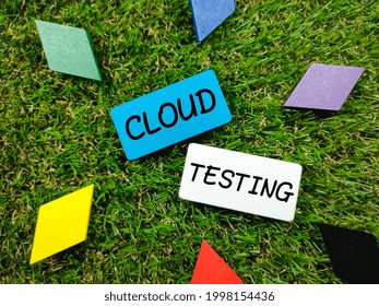 Text CLOUD TESTING on colorful wooden board on green grass background.