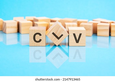 text CLV - written on the wooden cubes in black letters, the cubes are located on a bright blue glass surface. concept word forming with cubes on background. CLV - short for Customer Lifetime Value