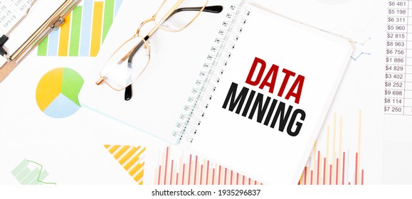 Text DATA MINING On White Notepad, Glasses, Graphs And Diagrams.