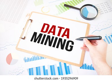 Text DATA MINING On White Paper Sheet And Marker On Businessman Hand On The Diagram. Business Concept