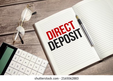 Text Direct Deposit On Brown Diary With Calculator, Glasses On Wooden Background