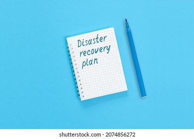 The Text Disaster Recovery Plan Is Written On A Notebook Page. Concept Photo Signifying Disaster Relief Plan Concept - A Plan For The Rapid Elimination Of The Natural Disasters Or Industrial Accidents