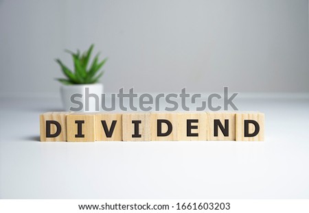 Text DIVIDEND on cube dice with background, finance concept