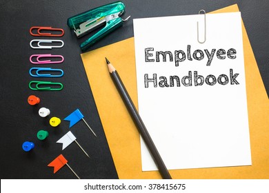 Text Employee Handbook On White Paper / Business Concept