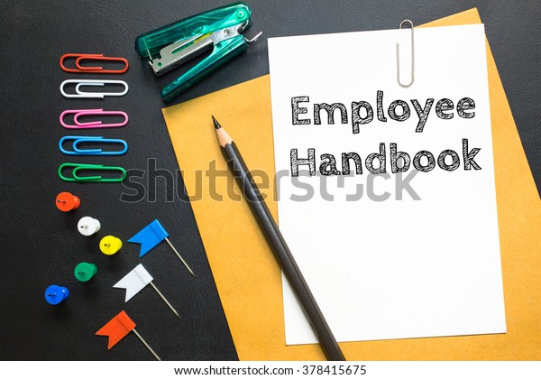 Text\
Employee handbook on white paper / business\
concept