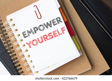 Text Empower yourself on white paper on laptop computer / business concept