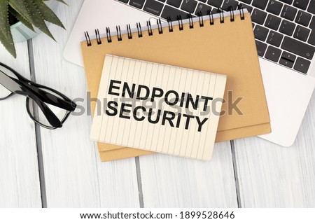 Text ENDPOINT SECURITY on brown paper notepad in businessman hands in office. Business concept