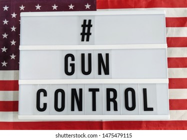 Text In English Spelling Hashtag Gun Control Against United States Of America Flag Background. Sign With A Message. 