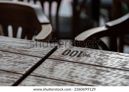 Text Engraved on Wooden Table One Hundred Percent