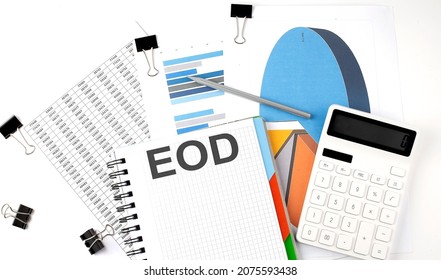 Text EOD on a notebook on diagram and charts with calculator and pen