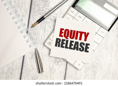 Text Equity Release on paper card and calculator on wooden background - Shutterstock ID 2186470491