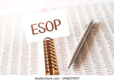 Text ESOP on paper card,pen, financial documentation on table - business, banking, finance and investment concept. close up of stock market chart.
