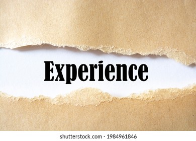 The text, experience, appears behind torn brown paper