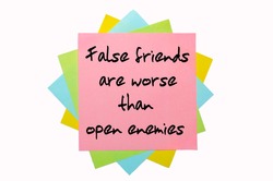 Text "  False Friends Are Worse Than Open Enemies " Written By Hand Font On Bunch Of Colored Sticky Notes