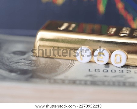 Text FED message is placed on the dollar and glod bar. Every meeting of the Fed and the economy.