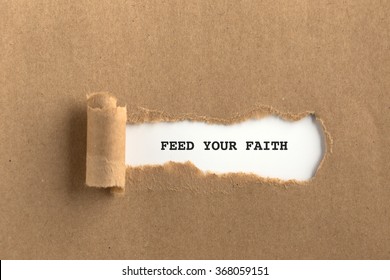 The text FEED YOUR FAITH behind torn brown paper