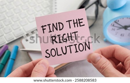 text Find The Right Solution on brown diary with calculator, glasses on wooden background