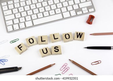 Text: FOLLOW US from wooden letters on white office desk - Powered by Shutterstock